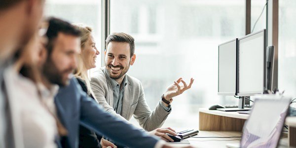 Co-workers having a conversation by laptop